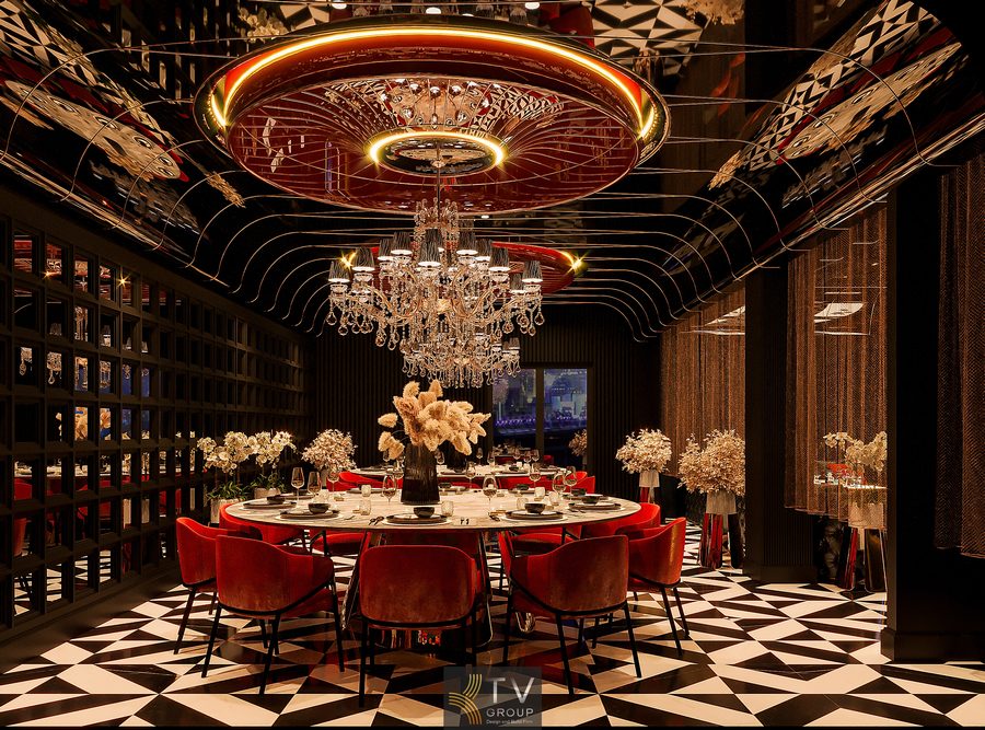 Phòng VIP nhà hàng thiết kế theo concept private dining, nổi bật với đèn chùm pha lê lớn, trần gương nghệ thuật, bàn tròn đá marble và ghế nhung đỏ sang trọng.  Không gian phòng VIP nhà hàng cao cấp với ánh sáng vàng tinh tế, hệ đèn chùm pha lê, nội thất bọc nhung đỏ và bố cục bàn tròn giúp tăng tính riêng tư và thẩm mỹ. 