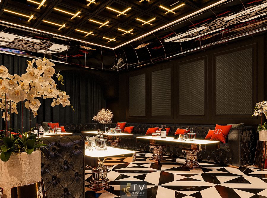 Thiết kế thi công phòng VIP nhà hàng cao cấp với không gian tiếp khách riêng tư, nội thất sang trọng, ánh sáng nghệ thuật, bố cục chuẩn vận hành và trải nghiệm ẩm thực cao cấp.  Meta Keywords  thiết kế phòng vip nhà hàng, thi công phòng vip cao cấp, phòng tiếp khách nhà hàng sang trọng, nội thất nhà hàng vip, KTV Group  ALT ẢNH  Phòng VIP nhà hàng cao cấp với sofa bọc da tối màu, bàn dài trung tâm, trần gương uốn cong, hệ đèn LED tuyến tính và sàn họa tiết đen trắng sang trọng.  PHONG CÁCH & CONCEPT  Phong cách: Luxury Contemporary – sang trọng đương đại, tiết chế chi tiết nhưng giàu chiều sâu.  Concept: Private Lounge Dining – không gian tiếp khách riêng tư kết hợp ẩm thực, đề cao trải nghiệm, sự kín đáo và cảm giác “được thiết kế riêng”.  MÔ TẢ THIẾT KẾ – THI CÔNG (SÁT ẢNH)  Phòng VIP được thiết kế theo bố cục dạng lounge khép kín, diện tích ước tính 40–55m², phù hợp tiếp khách quan trọng, họp mặt riêng hoặc tiệc thân mật quy mô nhỏ. Hai dãy sofa đối xứng chạy dọc theo tường, kết hợp bàn dài trung tâm giúp tối ưu giao tiếp và tạo cảm giác sang trọng, vững chãi.  Nội thất nổi bật  Sofa bọc da cao cấp tông đen – điểm nhấn gối tựa đỏ tạo chiều sâu thị giác.  Bàn trung tâm mặt đá sáng, chân kim loại, dễ kết hợp nhiều hình thức sử dụng.  Sàn họa tiết hình học đen trắng, giúp không gian có nhịp điệu và nhận diện rõ ràng khu VIP.  Trần – ánh sáng  Trần gương uốn cong kết hợp hệ đèn LED tuyến tính chạy khung, tạo hiệu ứng chiều cao và phản chiếu ánh sáng mềm.  Ánh sáng chia lớp: ánh sáng nền – ánh sáng bàn – ánh sáng nhấn, dễ điều chỉnh theo từng ngữ cảnh tiếp khách.  Âm thanh – tiện nghi  Hệ loa âm trần bố trí kín, âm thanh rõ nhưng không dội.  Giải pháp cách âm tường – trần giúp đảm bảo riêng tư tuyệt đối, không ảnh hưởng khu vực khác.  ĐIỂM NHẤN ĐẶC BIỆT TRONG THIẾT KẾ (KTV GROUP)  Bố cục lounge đối xứng tạo cảm giác quyền lực – tiếp khách chuẩn mực  Trần gương kết hợp LED tuyến tính giúp không gian rộng hơn thực tế  Thiết kế tập trung vào trải nghiệm sử dụng dài hạn, hạn chế lỗi mốt  HẠNG MỤC THIẾT KẾ & THI CÔNG  Tư vấn concept & layout phòng VIP  Thiết kế 3D nội thất – ánh sáng  Thi công trần gương, đèn LED tuyến tính  Sản xuất & lắp đặt sofa, bàn, vách trang trí  Setup ánh sáng – âm thanh – hoàn thiện tổng thể  GỢI Ý RIÊNG CHO CHỦ ĐẦU TƯ (ĐỂ CHỐT PHƯƠNG ÁN)  Phòng VIP giúp tăng giá trị thương hiệu và giữ chân nhóm khách cao cấp  Thiết kế bền vững, ít chỉnh sửa trong quá trình vận hành  Không gian dễ bán gói tiếp khách, đặt tiệc riêng, nâng giá trị hóa đơn  KẾT LUẬN  Dự án phòng VIP nhà hàng này là sự kết hợp hài hòa giữa thẩm mỹ sang trọng, tính riêng tư và hiệu quả sử dụng. Thiết kế tập trung vào trải nghiệm tiếp khách chuẩn mực, ánh sáng tinh tế và bố cục vận hành hợp lý, giúp chủ đầu tư nâng tầm hình ảnh nhà hàng và tối ưu giá trị kinh doanh lâu dài.  Nếu bạn muốn, mình có thể viết thêm bản rút gọn chuẩn Ads, phiên bản thuyết minh để thuyết phục chủ đầu tư, hoặc chia thành nội dung web – hồ sơ năng lực – catalogue. 