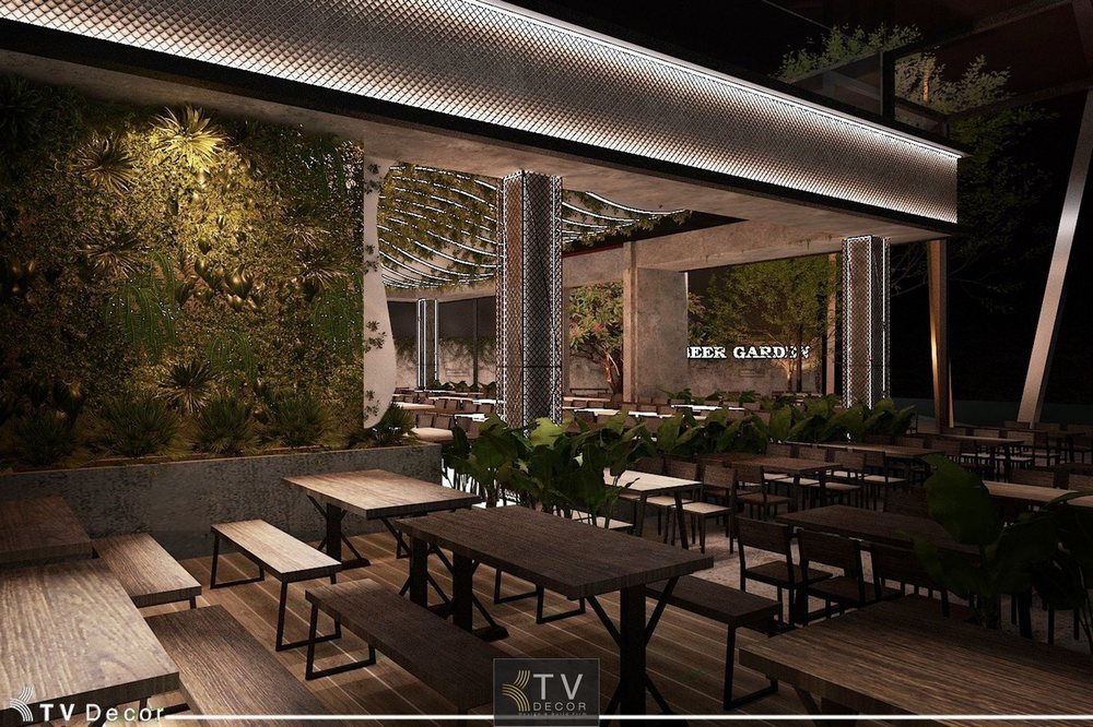 Không gian nội thất nhà hàng Beer Garden YOYO với thiết kế mở, bàn ghế gỗ hiện đại, hệ thực vật tường xanh và ánh sáng LED dịu nhẹ – Thiết kế bởi KTV Decor tại Hồ Con Rùa, TP.HCM.
