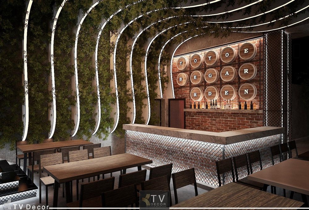 Quầy bar nhà hàng YOYO Beer Garden với thiết kế vòm cong ánh sáng, tường cây xanh và hệ thống thùng bia decor ấn tượng