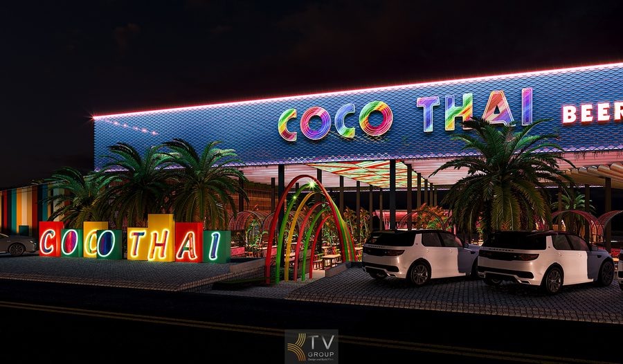 Mặt tiền COCO THAI Beer Garden được xây dựng theo phong cách Tropical Thai rực rỡ, với bảng chữ neon cỡ lớn và lối vòm cong nhiều màu kéo dài vào khu vực bên trong. Cây cọ hai bên tạo cảm giác thư giãn xen lẫn sự sôi động. Đây là không gian lý tưởng cho trải nghiệm ẩm thực và giải trí về đêm. 