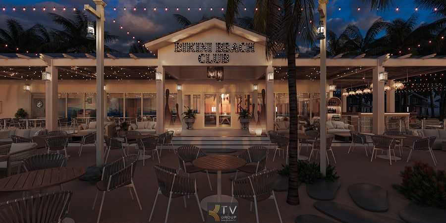 Khu ăn uống ngoài trời có mái che nhẹ, đèn treo và cây xanh, đem lại sự hài hòa giữa ánh sáng ấm và cảnh biển ban đêm.