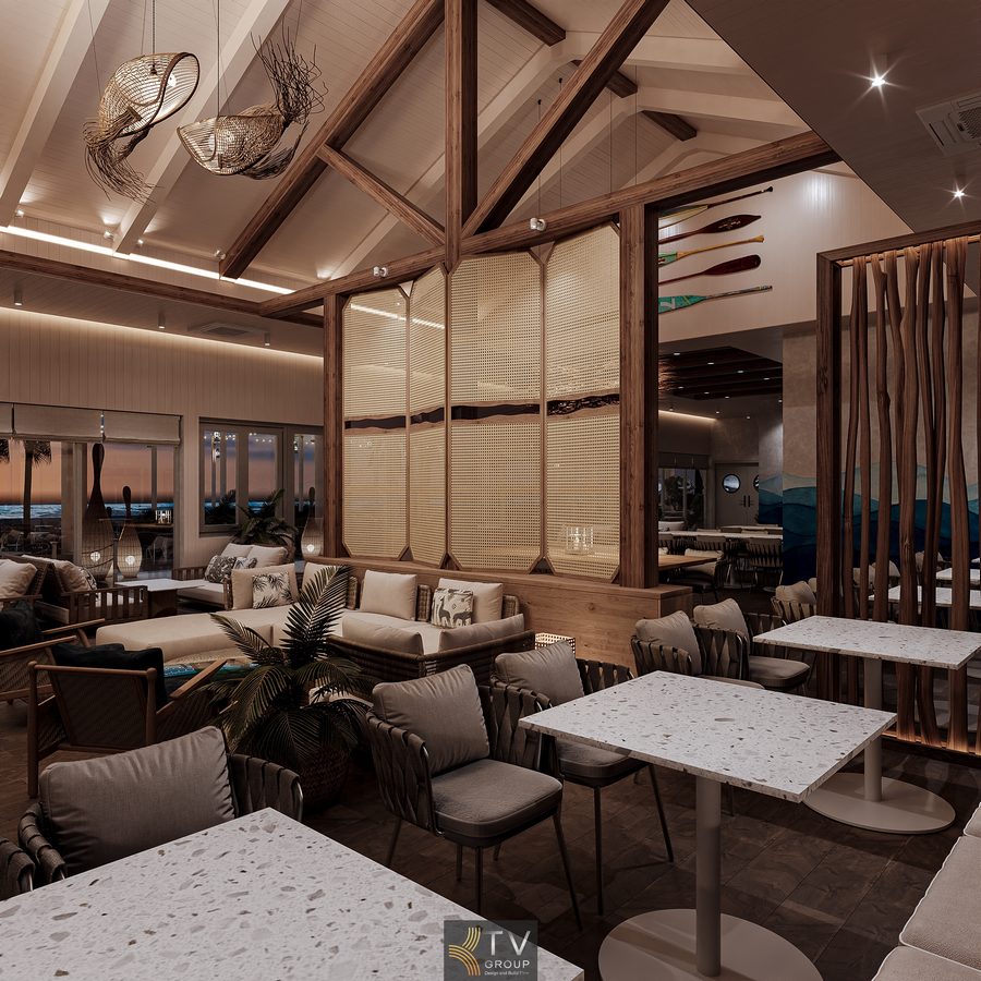 Góc ngồi hồ điệp của nhà hàng với ghế mây và ánh đèn vàng, bao quanh bởi hàng dừa và gió biển mát mẻ.