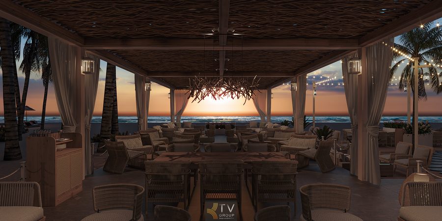 Không gian nhà hàng ngoài trời hướng biển vào lúc hoàng hôn, với bàn ghế mây, rèm trắng, ánh đèn vàng và hàng dừa trải dài bên bờ biển.