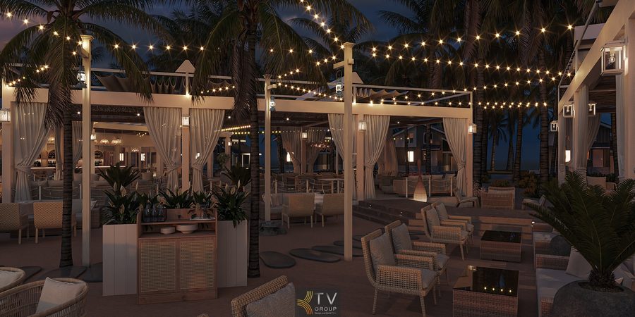 Không gian nhà hàng ven biển buổi tối với hệ thống đèn dây trang trí, nội thất mây tre và rèm trắng tạo không khí sang trọng, thư giãn giữa hàng dừa nhiệt đới.