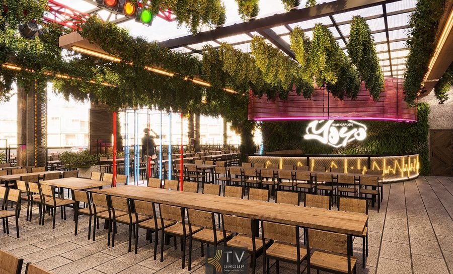 Không gian Beer Garden được thiết kế thoáng mở với bàn gỗ dài, hệ trần phủ cây xanh tạo cảm giác mát mẻ. Ánh sáng LED và khu quầy bar nổi bật mang đến không khí trẻ trung, sôi động cho nhà hàng.