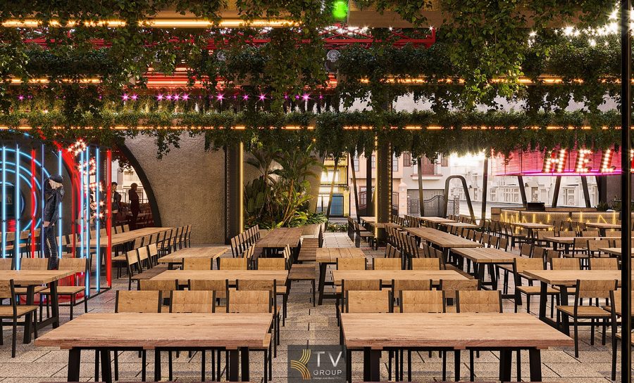 Không gian ẩm thực Beer Garden rộng rãi với bàn ghế gỗ mộc mạc. Thiết kế thi công Beer Garden phong cách xanh với ánh sáng sân khấu.