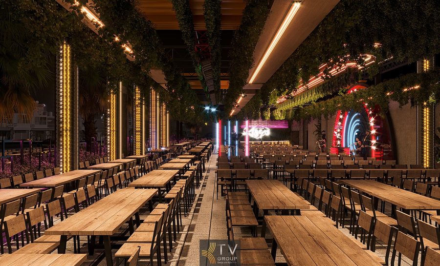 Không gian nhà hàng Beer Garden được bố trí nhiều bàn gỗ dài, đèn LED nổi bật và mảng xanh treo giúp tạo nên không khí trẻ trung, náo nhiệt.