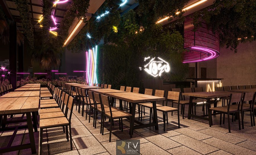 Beer Garden thiết kế thoáng rộng với hàng ghế gỗ, ánh sáng trang trí đa màu sắc và mái che phủ cây xanh tạo sự mát mẻ và thu hút. Nhà hàng Beer Garden sử dụng bàn gỗ dài, hệ thống đèn nhiều màu và trần cây xanh tạo nên không gian ẩm thực – giải trí đầy năng lượng.