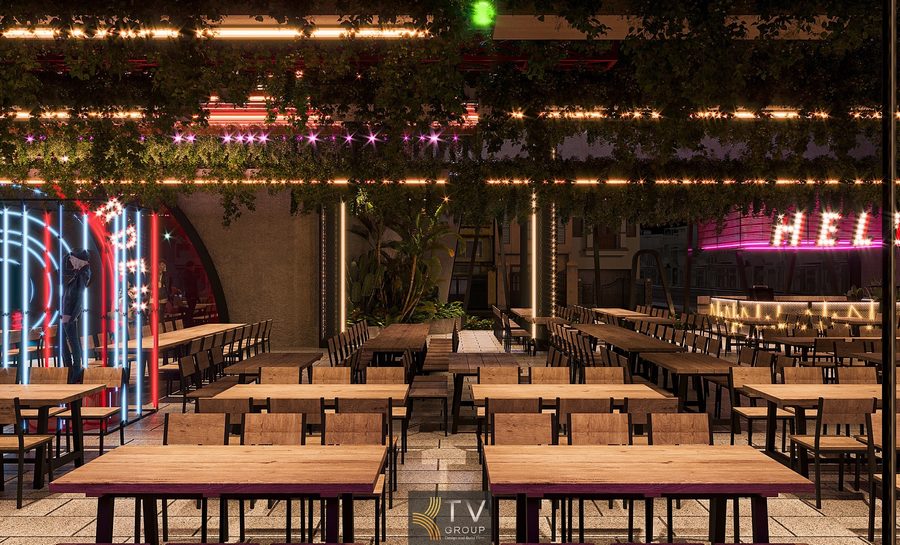 Thiết kế thi công nhà hàng Beer Garden với không gian mở hiện đại, bàn gỗ dài, trần xanh treo ấn tượng và sân khấu ánh sáng nổi bật, tạo trải nghiệm ẩm thực – giải trí sôi động.