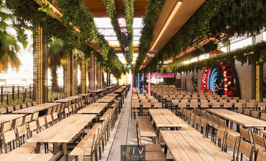 Thiết kế thi công xây dựng nhà hàng Beer Garden không gian mở hiện đại với bàn gỗ và trần cây xanh.
