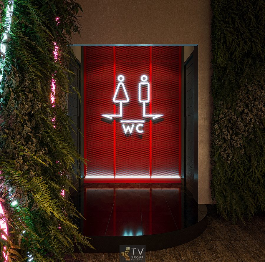 Lối vào khu WC Beer Garden Phan Thiết thiết kế đèn LED đỏ nổi bật với biểu tượng nam nữ hiện đại.