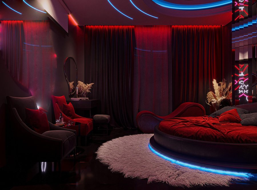 Nội thất phòng love hotel phong cách Neon Romantic Luxury sử dụng LED đa sắc, màu đỏ chủ đạo và điểm nhấn gương nghệ thuật tăng chiều sâu không gian. 