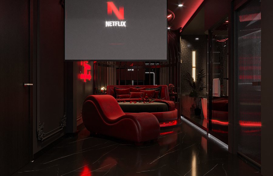 Không gian phòng khách sạn được thiết kế theo phong cách hiện đại tối màu kết hợp sắc đỏ ánh kim tạo cảm giác sang trọng và cuốn hút