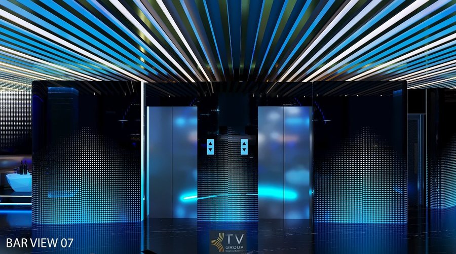 Không gian quầy DJ – Bar trung tâm nổi bật với cột pha lê phát sáng, hiệu ứng ánh sáng xanh huyền ảo và thiết kế vòm kim loại hiện đại, tạo điểm nhấn sang trọng cho toàn bộ Lounge 1