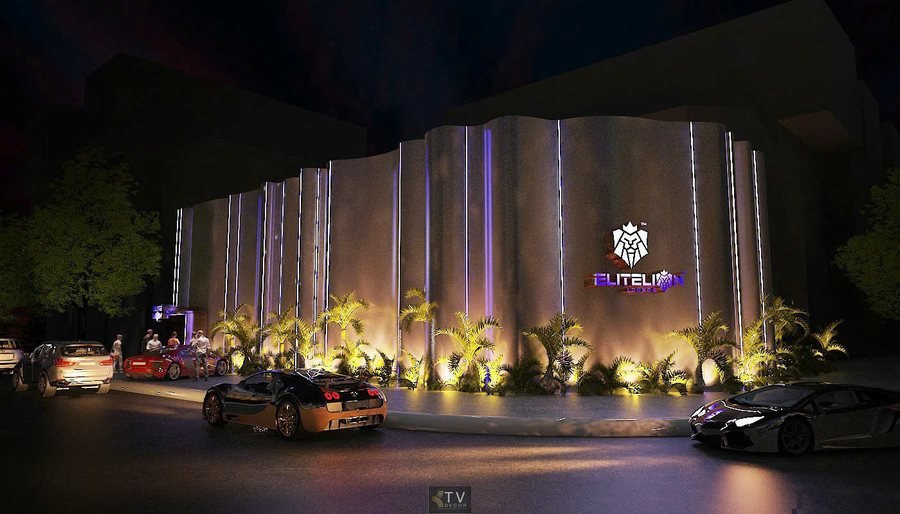 Alt: Mặt tiền Elite Lion Lounge với tường cong kim loại, hệ LED đỏ tím và logo sư tử phát sáng.