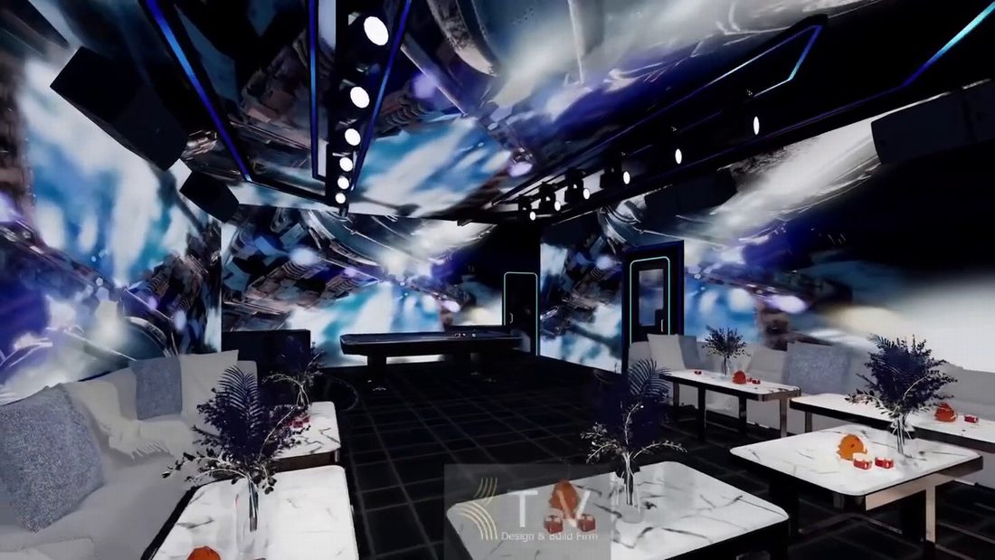 Nội thất Karaoke VIP với sofa trắng, bàn đá và hiệu ứng ánh sáng 5D. 