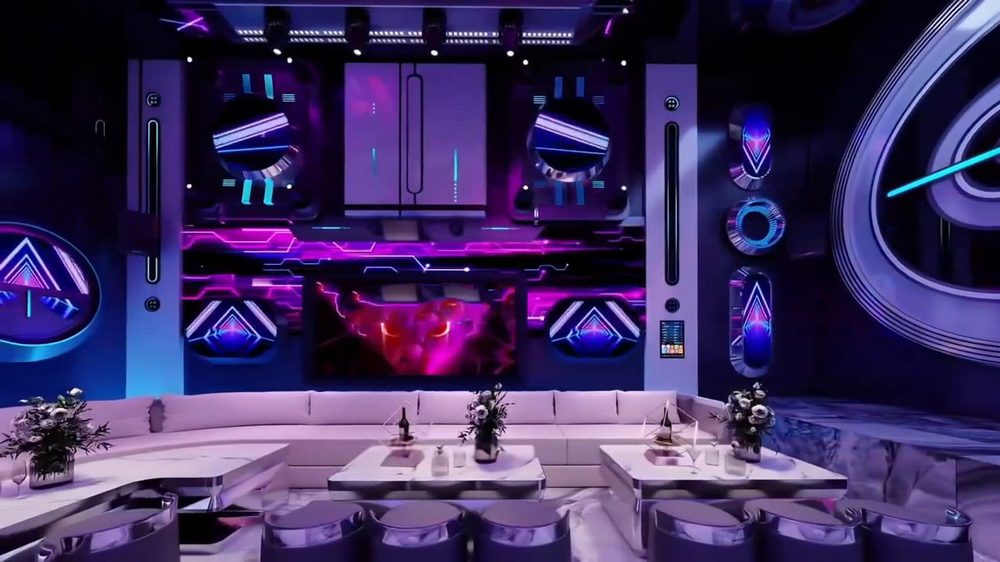 Thiết kế phòng karaoke hiện đại phong cách Futuristic với hệ LED tím xanh, nội thất sofa trắng sang trọng và ánh sáng công nghệ cao.