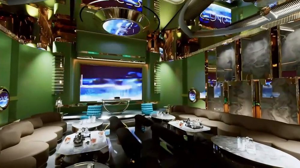 Mẫu thiết kế karaoke Luxury sang trọng sử dụng sofa cong, bàn đá vân mây và màn hình LED kích thước lớn. 