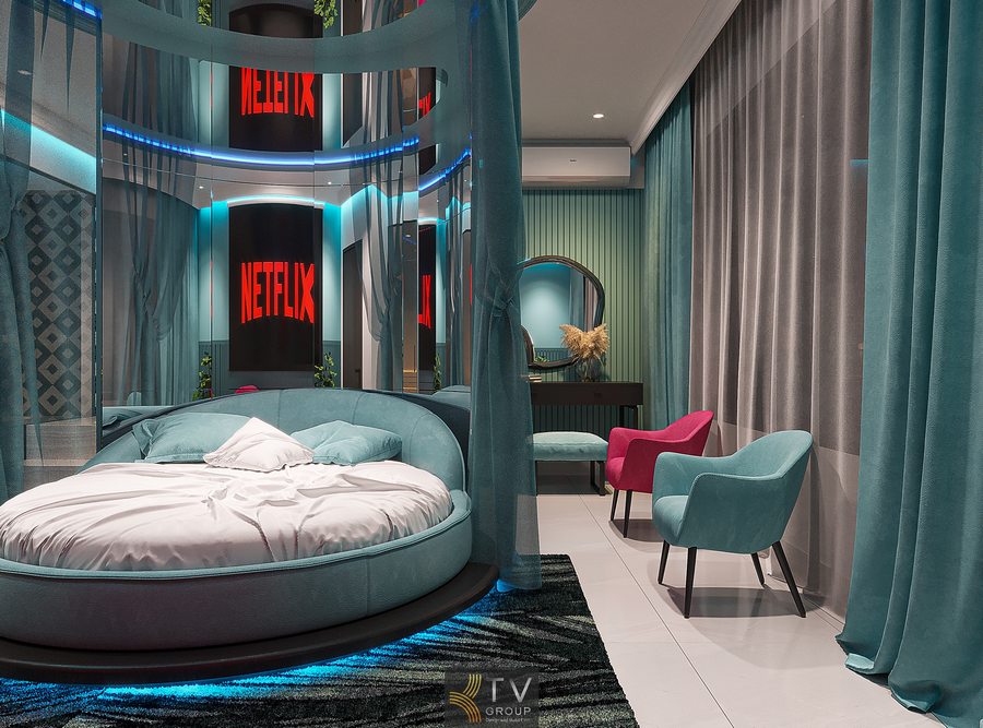 Phòng khách sạn cao cấp với giường tròn trung tâm, vách kính trong suốt và ánh sáng LED xanh tạo không gian hiện đại, rộng rãi và ấn tượng 