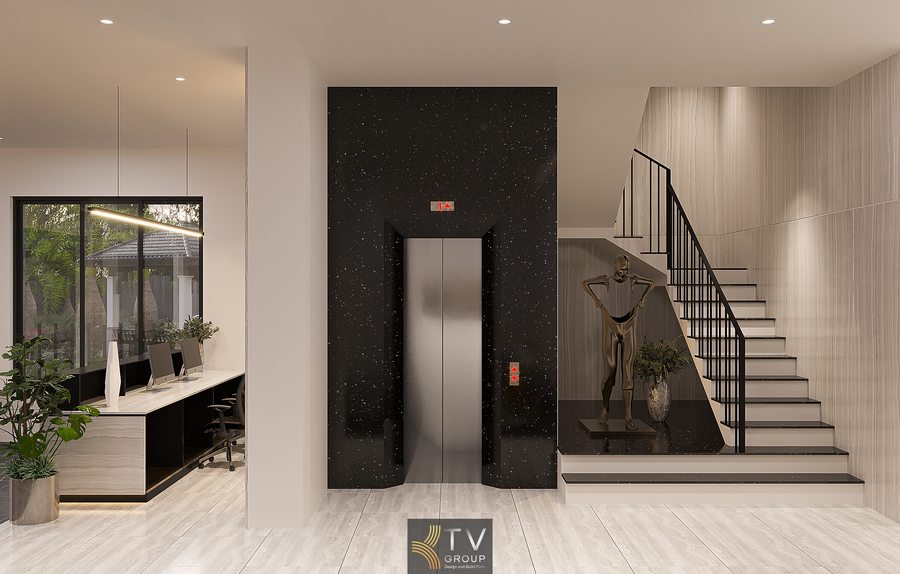 Không gian lễ tân khách sạn sang trọng với đèn trần hiện đại và quầy đá tạo điểm nhấn nổi bật