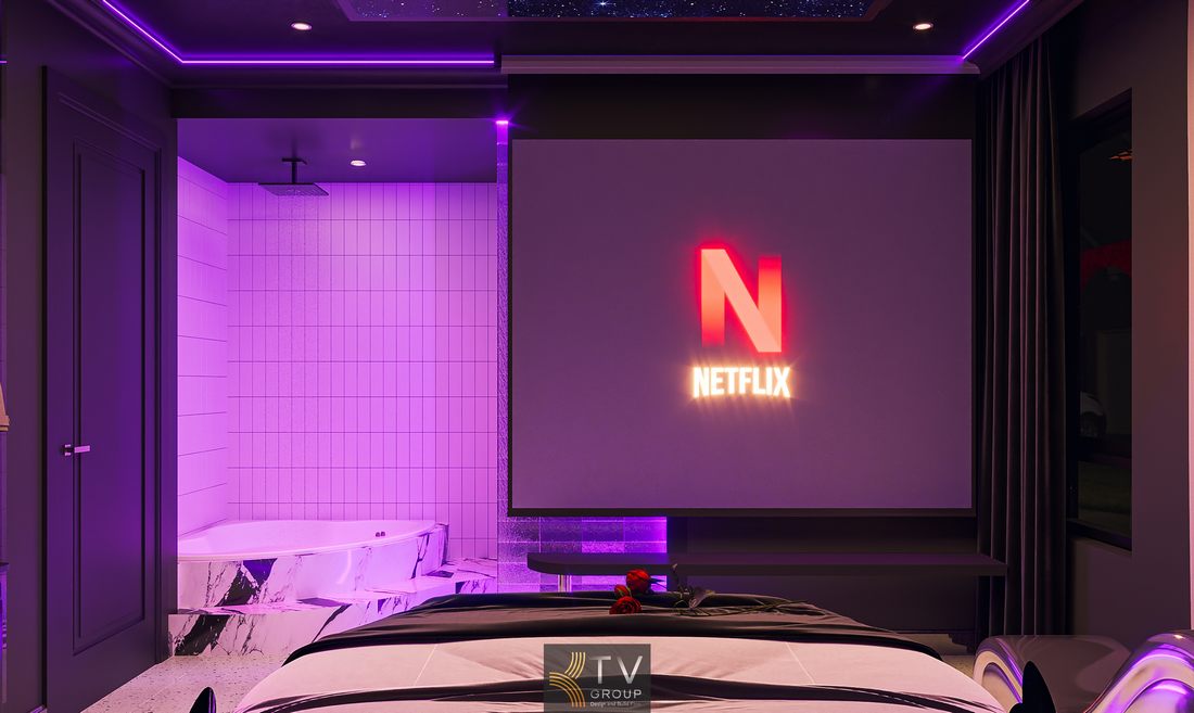 Không gian phòng ngủ khách sạn cao cấp với giường tròn trung tâm, ánh sáng LED đổi màu linh hoạt, kết hợp tông màu tím – đen tạo chiều sâu thị giác mạnh mẽ 