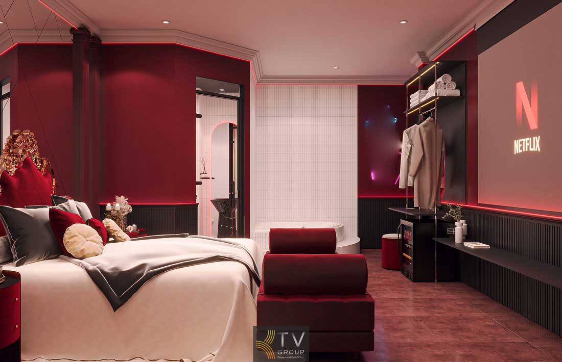 Không gian phòng ngủ khách sạn cao cấp với tông màu đỏ – kem hài hòa, nội thất đồng bộ và ánh sáng ấm mang lại cảm giác dễ chịu 