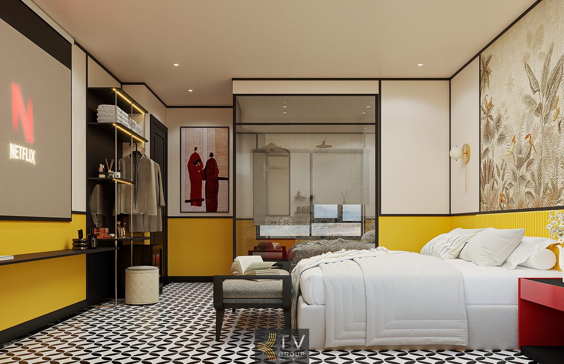 Phòng khách sạn thiết kế theo concept trải nghiệm với màu sắc nổi bật, giường trung tâm, ghế cuối giường tiện dụng và ánh sáng dịu nhẹ phù hợp nhu cầu lưu trú ngắn hạn.