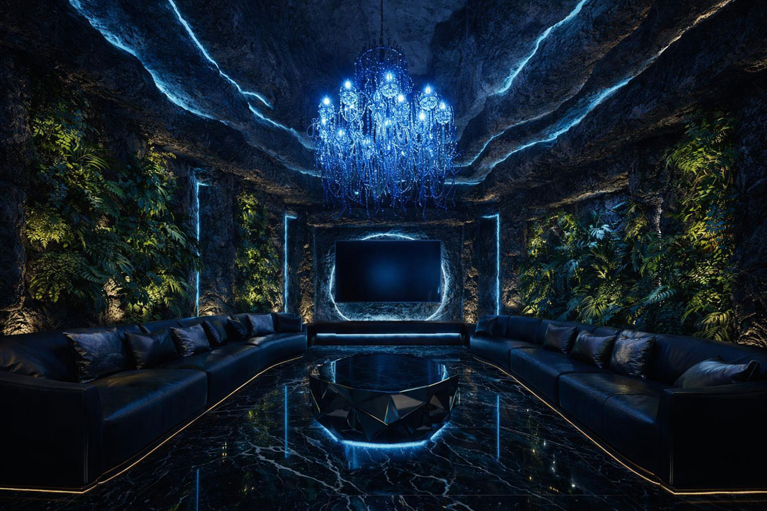 Phòng karaoke hang động luxury ánh sáng xanh với trần đá mô phỏng tự nhiên, đèn chùm pha lê xanh, sofa da cao cấp và sàn đá bóng sang trọng.