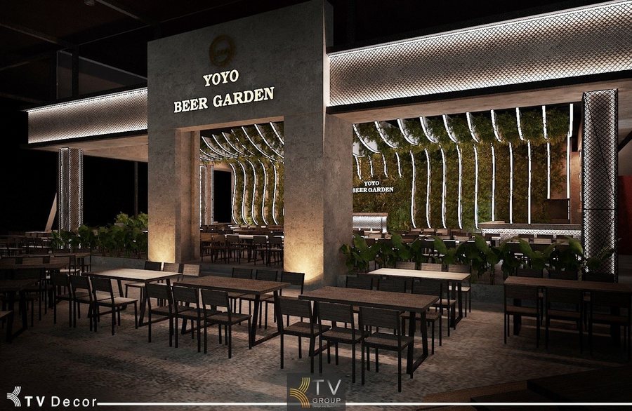 Không gian nội thất YOYO Beer Garden được thiết kế theo phong cách Beer Garden hiện đại với bố cục mở, tạo sự thoáng đãng và kết nối tự nhiên giữa các khu vực. Điểm nhấn nổi bật là hệ lam ánh sáng chạy dọc theo trần và mảng tường xanh, mang lại hiệu ứng thị giác mạnh và cảm giác năng động về đêm. Bàn ghế được bố trí đồng bộ, chất liệu bền vững, phù hợp cho mô hình phục vụ công suất lớn. Thiết kế này giúp YOYO Garden tối ưu trải nghiệm khách hàng và tạo dấu ấn riêng giữa trung tâm Hồ Con Rùa. 