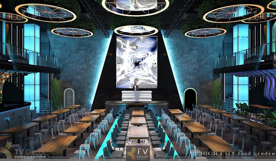 Không gian Beer Food Garden được thiết kế theo phong cách hiện đại với điểm nhấn mạnh về ánh sáng – kiến trúc – trải nghiệm thị giác. Hình ảnh thể hiện một bố cục mở, trần cao, hệ thống vòng đèn LED nghệ thuật thả từ trên xuống, tạo hiệu ứng thị giác phá cách. 