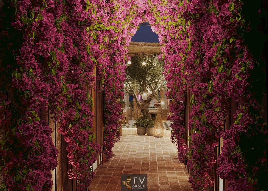 Thiết kế Beer Garden ban đêm lãng mạn. Ánh sáng vàng rực rỡ, cây xanh lớn, sàn gạch họa tiết. 