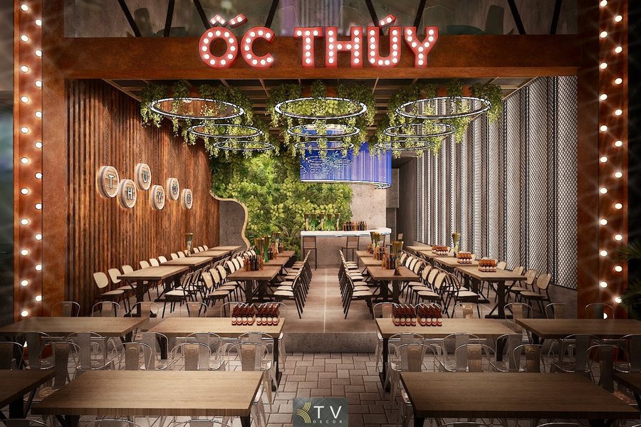 Không gian Nhà hàng Ốc Thúy được thiết kế hiện đại với điểm nhấn mặt tiền đèn LED nổi bật, bộ khung thép màu rust độc đáo, mảng xanh treo trần và hệ bàn ghế bố trí khoa học. Giải pháp thi công tối ưu chi phí nhưng vẫn đảm bảo độ bền, thẩm mỹ và trải nghiệm khách hàng trong quy mô 500m². 